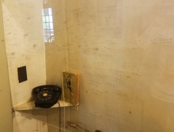 Connected to the pantry, Faulkner scribbled contact's phone numbers onto the wall behind the home's telephone.